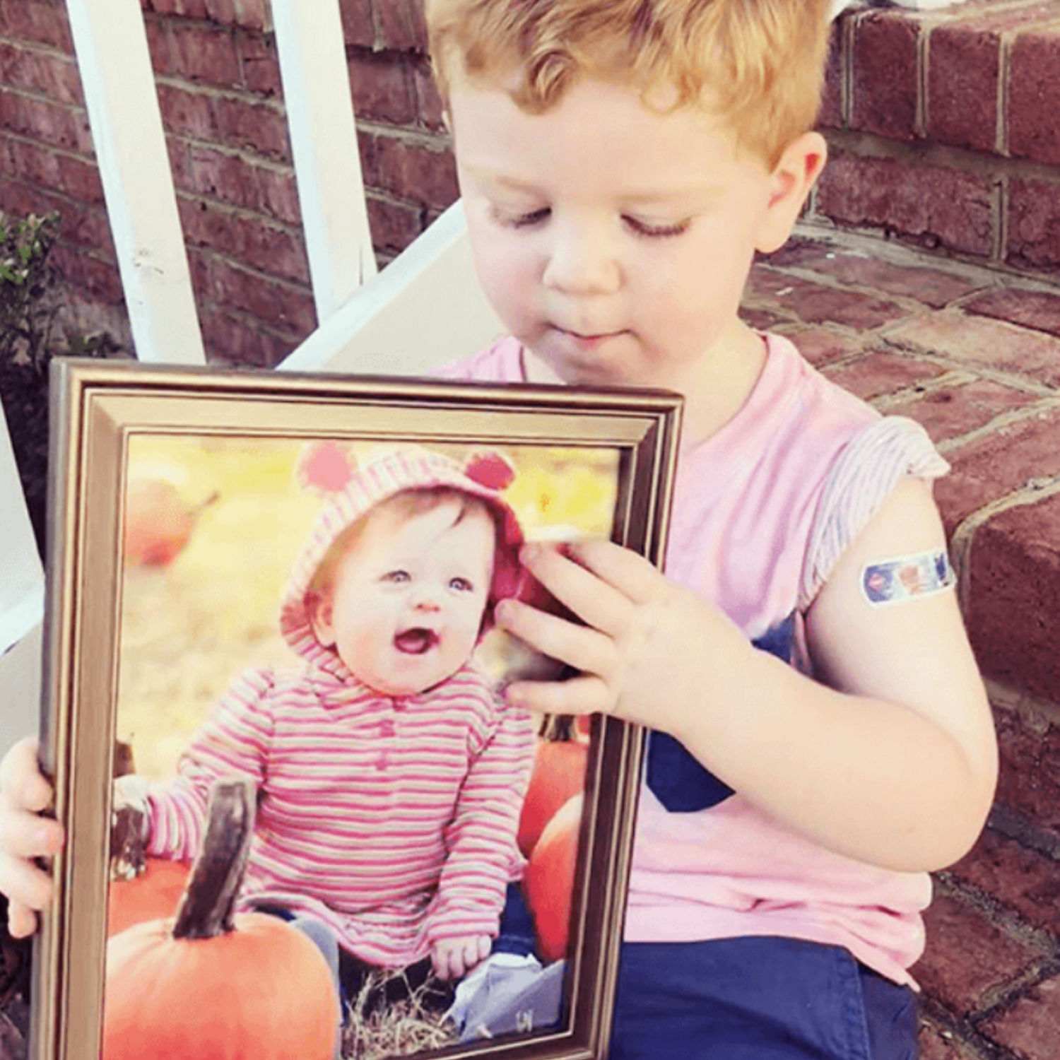 child holding framed photo