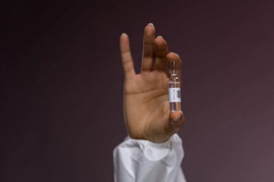 hand holding vaccine